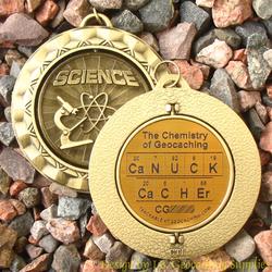 CaNUCK CaCHEr - The Chemistry of Geocaching - Antique Gold Geomedal Spinner