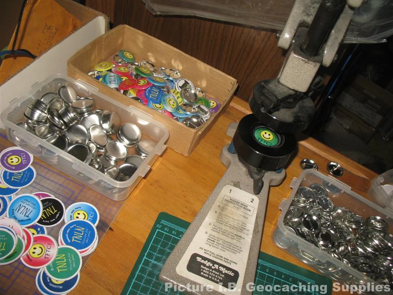 Geocaching buttons being made.